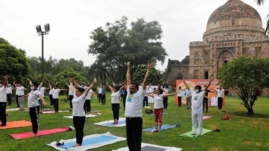 Participants, some wearing protective face masks against the coronavirus disease (Covid-19) outbreak, perform yoga during World Yoga Day in New Delhi. (REUTERS)