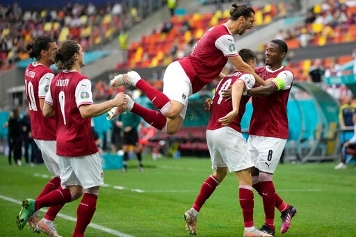 Austria's Christoph Baumgartner (9) celebrates after scoring his side's opening goal during the Euro 2020 soccer championship group C match between Ukraine and Austria at the National Arena stadium in Bucharest, Monday, June 21, 2021. (AP Photo/Vadim Ghirda) Austria's Christoph Baumgartner (9) celebrates after scoring his side's opening goal during the Euro 2020 soccer championship group C match between Ukraine and Austria at the National Arena stadium in Bucharest, Monday, June 21, 2021. (AP Photo/Vadim Ghirda)