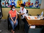 A healthcare worker inoculates a girl with the first dose of the Covishield vaccine at a school in New Delhi on Monday. (ANI Photo) A healthcare worker inoculates a girl with the first dose of the Covishield vaccine at a school in New Delhi on Monday. (ANI Photo)
