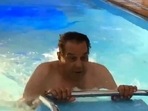 Dharmendra practices water aerobics in his swimming pool.