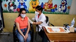 A healthcare worker inoculates a girl with the first dose of the Covishield vaccine at a school in New Delhi on Monday. (ANI Photo) A healthcare worker inoculates a girl with the first dose of the Covishield vaccine at a school in New Delhi on Monday. (ANI Photo)