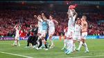 Denmark's players and staff celebrate after the match against Russia. (Pool via REUTERS) Denmark's players and staff celebrate after the match against Russia. (Pool via REUTERS)