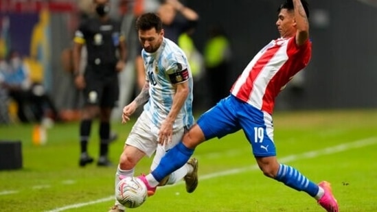 Argentina's Lionel Messi and Paraguay Santiago Arzamendia battle for the ball during a Copa America soccer match(AP)