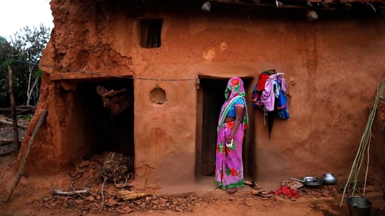 A woman looks on from her house in Jamsoti village, Uttar Pradesh on June 8. A deadly surge of coronavirus infections that ripped through India in April and May, killing more than 180,000, has tapered off and new cases have declined. But the relief could be fleeting as a significant amount of the population is still reluctant to get the shots, AP reported.(Rajesh Kumar Singh / AP)