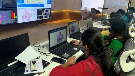 IT professionals assisting municipal authorities inside a "war room" focused on tracking the spread of Covid-19 in Bengaluru, India. (Reuters)