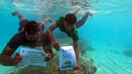 People hold placards during a 12-hour hunger strike against the alleged anti-people policies brought in by the Lakshadweep administration, in Lakshadweep from earlier (ANI Photo)