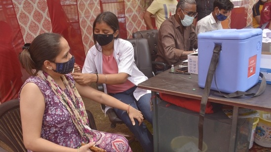 A health worker administers a dose of the Covid-19 vaccine in Ghaziabad, India. (Sakib Ali /Hindustan Times)