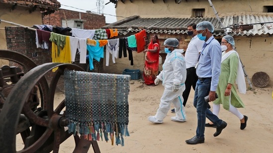 Health workers arrive to test villagers for Covid-19 and to persuade them to get vaccinated, at Sikanderpur village, Uttar Pradesh on June 9. “Vaccine hesitancy poses a risk to ending the pandemic in India,” retired virologist and paediatrician Dr T Jacob John told AP. “The more the virus circulates, the more it can mutate into dangerous new variants that can undermine vaccines,” he added.(Rajesh Kumar Singh / AP)