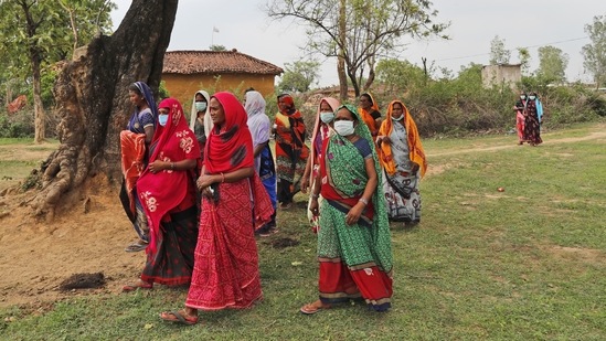 Women returning to their village after attending an awareness program on getting tested and vaccinated against Covid-19 in Jamsoti village, Uttar Pradesh on June 10. Rumours about jabs disrupting the menstruation cycle and reducing fertility have also contributed to fear and skewed the data in favour of men. In almost every Indian state, more men are getting vaccinated than women — and that gap is widening further every day.(Rajesh Kumar Singh / AP)