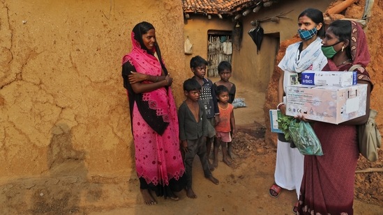 A health worker persuades a village woman to get vaccinated against Covid-19 at Jamsoti village, Uttar Pradesh on June 8. “We have to convince people, go door to door, and rely on people who have taken the vaccine to spread the word,” Yogesh Kalkonde, a public health doctor in Gadchiroli, Maharashtra, told AP. “It’s an extremely slow process.”(Rajesh Kumar Singh / AP)