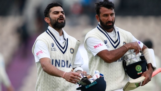 India's captain Virat Kohli, left, and Cheteshwar Pujara walk off the field at the end of play on the fifth day of the World Test Championship final. (AP) India's captain Virat Kohli, left, and Cheteshwar Pujara walk off the field at the end of play on the fifth day of the World Test Championship final. (AP)