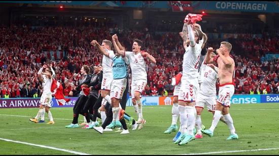 Denmark's players and staff celebrate after the match against Russia. (Pool via REUTERS)