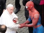 Pope Francis receives a Spiderman mask from a person dressed as Spiderman after the general audience, amid the coronavirus disease (Covid-19) pandemic, at the Vatican, June 23, 2021. (Reuters)