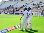 Virat Kohli and Cheteshwar Pujara waiting to get on to the field 