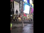 The image shows the man riding a drone-like structure and gliding across Times Square. The image shows the man riding a drone-like structure and gliding across Times Square.