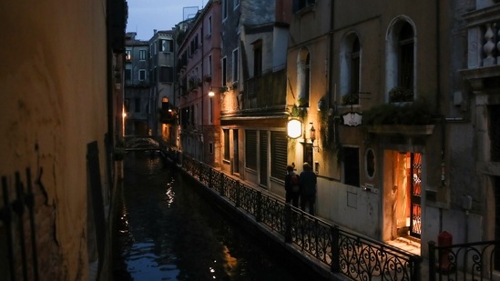 A couple walk near a canal in Venice, Italy. UNESCO has recommended adding Venice to its endangered heritage list.(Reuters File Photo.)