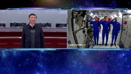 Chinese astronauts salute as they speak to President Xi Jinping via a video call from the Tianhe core module of China's space station.(via Reuters)