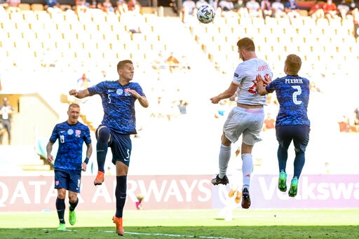 Spain's Aymeric Laporte, second right, heads the ball and scores his team second goal during the Euro 2020 group E match between Slovakia. His header took Spain into the break with a 2-0 lead. (AP)