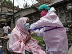 A woman receives a dose of the Covid-19 vaccine during a door-to-door vaccination and testing drive in the Howrah district of West Bengal. A woman receives a dose of the Covid-19 vaccine during a door-to-door vaccination and testing drive in the Howrah district of West Bengal.