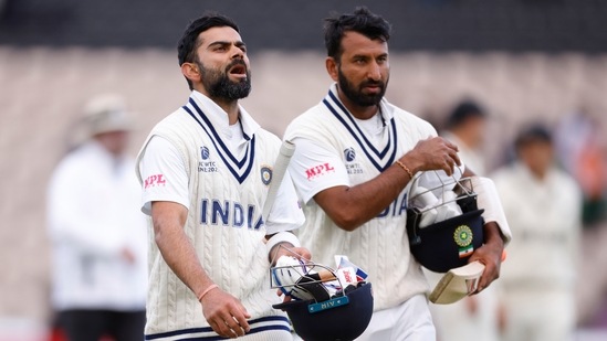  India's Virat Kohli and Cheteshwar Pujara walk off(Action Images via Reuters)