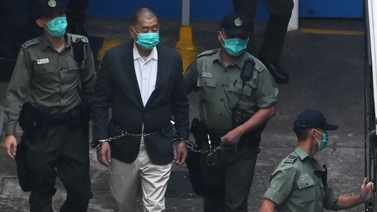 Owner of the Apple Daily newspaper, Jimmy Lai being led into a police van as he heads to court to be charged under Hong Kong's new national security law, on December 12, 2020. Additionally, five executives were arrested and two - chief editor Ryan Law, 47, and Cheung Kim-hung, 59 - were charged with conspiracy to commit collusion with a foreign country and denied bail. On June 23, a 55-year-old columnist for the paper was also arrested under the national security law, Reuters reported. (Peter Parks / AFP) Owner of the Apple Daily newspaper, Jimmy Lai being led into a police van as he heads to court to be charged under Hong Kong's new national security law, on December 12, 2020. Additionally, five executives were arrested and two - chief editor Ryan Law, 47, and Cheung Kim-hung, 59 - were charged with conspiracy to commit collusion with a foreign country and denied bail. On June 23, a 55-year-old columnist for the paper was also arrested under the national security law, Reuters reported. (Peter Parks / AFP)