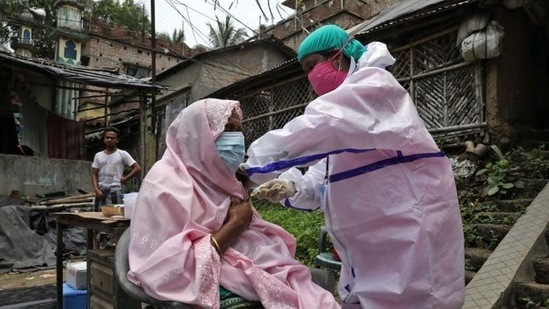 A woman receives a dose of the Covid-19 vaccine during a door-to-door vaccination and testing drive in the Howrah district of West Bengal. (Reuters) A woman receives a dose of the Covid-19 vaccine during a door-to-door vaccination and testing drive in the Howrah district of West Bengal. (Reuters)