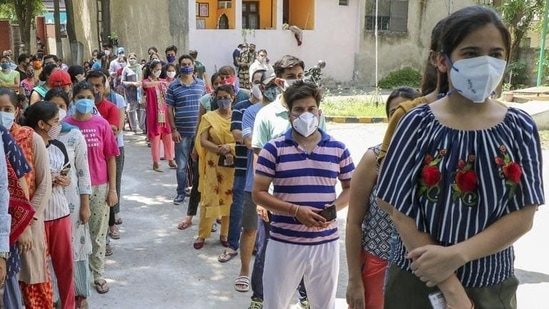 Beneficiaries wait in a queue to receive a dose of Covid vaccine at a vaccination centre in Jammu. Beneficiaries wait in a queue to receive a dose of Covid vaccine at a vaccination centre in Jammu.