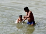 People take bath in the river Yamuna on a hot summer day in New Delhi on Friday. (ANI Photo) People take bath in the river Yamuna on a hot summer day in New Delhi on Friday. (ANI Photo)