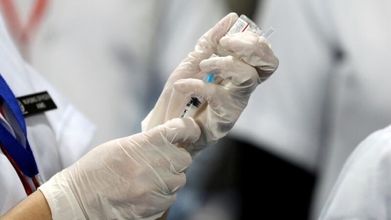 A healthcare worker fills a syringe with a dose of Bharat Biotech's Covid-19 vaccine called Covaxin, during the coronavirus disease (Covid-19) vaccination campaign at All India Institute of Medical Sciences (AIIMS) hospital in New Delhi, India, January 16, 2021. (REUTERS)