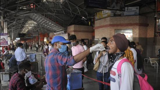 A health worker collects a swab sample at the Charbagh railway station in Lucknow. (Deepak Gupta/HT Photo) A health worker collects a swab sample at the Charbagh railway station in Lucknow. (Deepak Gupta/HT Photo)