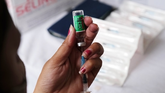 A health worker prepares a dose of the Covishield vaccine, developed by Oxford-AstraZeneca Plc. and manufactured by Serum Institute of India Ltd., for a student, who has a place to study abroad, at a Covid-19 vaccination center set up in a school in New Delhi India, on Thursday, June 24, 2021. (Bloomberg)