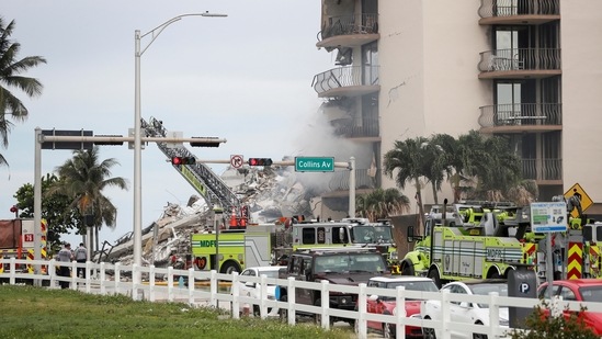 Emergency crew members searching for missing residents in the partially collapsed building in Surfside on June 24. Search teams detected sounds of banging and other noises but no voices coming from the mounds of debris hours after a large section of the Champlain Towers South condominium crumbled to the ground, authorities said.(Octavio Jones / Reuters)