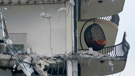 A hanging chair sits on what is left of a balcony on the building that partially collapsed on June 24 in Surfside. Officials said the complex, built in 1981, was going through a re-certification process requiring repairs, with another building under construction on an adjacent site.(Wilfredo Lee / AP)