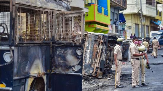 Security personnel at a riot-hit area after a mob went on a rampage over a social media post in Bengaluru on August 13, 2020. (PTI) Security personnel at a riot-hit area after a mob went on a rampage over a social media post in Bengaluru on August 13, 2020. (PTI)