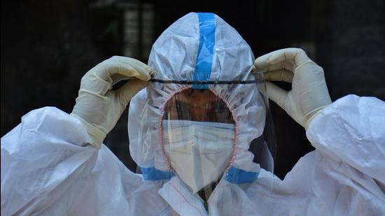 File photo: Healthcare worker in PPE kit taking a break between the duty at Thane Civil Hospital, Maharashtra. (HT PHOTO)