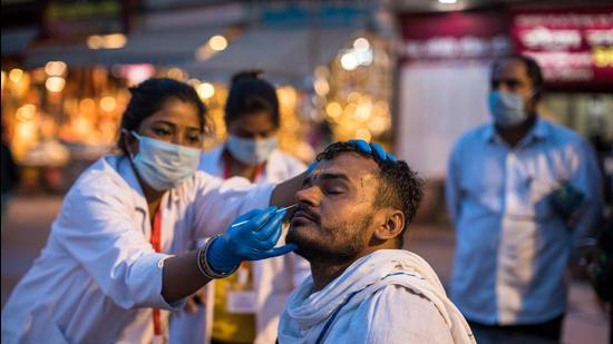 A health worker collects a nasal swab sample from a pilgrim for Covid testing during the Kumbh Mela in Haridwar on April 12. (File photo) A health worker collects a nasal swab sample from a pilgrim for Covid testing during the Kumbh Mela in Haridwar on April 12. (File photo)