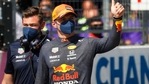 Red Bull's Max Verstappen wears a protective face mask as he celebrates finishing in pole position.(REUTERS)
