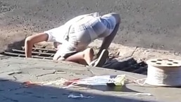 The image shows a boy trying to rescue a cat in Brazil.