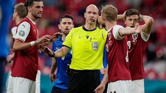 Austria's players talk with a referee Anthony Taylor during the Euro 2020 soccer championship round of 16 match between Italy and Austria at Wembley stadium in London, Saturday, June 26, 2021. (AP Photo/Frank Augstein, Pool) (AP) Austria's players talk with a referee Anthony Taylor during the Euro 2020 soccer championship round of 16 match between Italy and Austria at Wembley stadium in London, Saturday, June 26, 2021. (AP Photo/Frank Augstein, Pool) (AP)