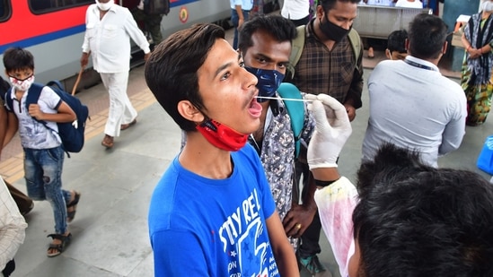 A health worker collects swab samples of incomming travellers for Covid-19 tests, at Dadar station in Mumbai on June 24. Out of the total 51 cases of Delta Plus in the country, 22 have been reported in Maharashtra, followed by nine in Tamil Nadu, seven in Madhya Pradesh, three in Kerala, two each in Punjab and Gujarat, and one case each in Andhra Pradesh, Odisha, Rajasthan, Jammu and Kashmir, Haryana and Karnataka, HT reported.(Bhushan Koyande / HT Photo)