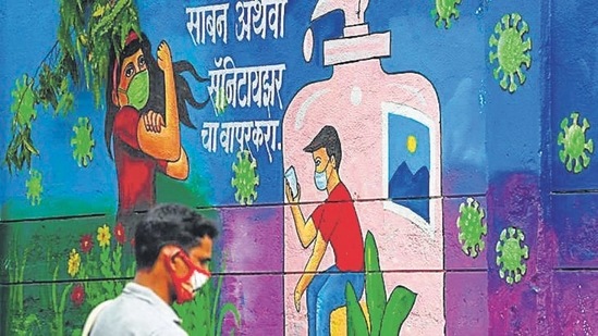 A pedestrian walks past a wall mural representing awareness measures against the Covid-19 coronavirus, in Navi Mumbai on June 6. (File photo) A pedestrian walks past a wall mural representing awareness measures against the Covid-19 coronavirus, in Navi Mumbai on June 6. (File photo)