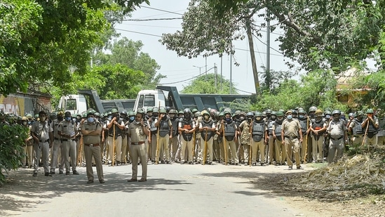 Delhi Police officials deployed near the protest site of farmers observing June 26 as 'Save Agriculture, Save Democracy' Day to mark seven months of their protest against three farm reform laws, at Singhu border. (PTI) Delhi Police officials deployed near the protest site of farmers observing June 26 as 'Save Agriculture, Save Democracy' Day to mark seven months of their protest against three farm reform laws, at Singhu border. (PTI)