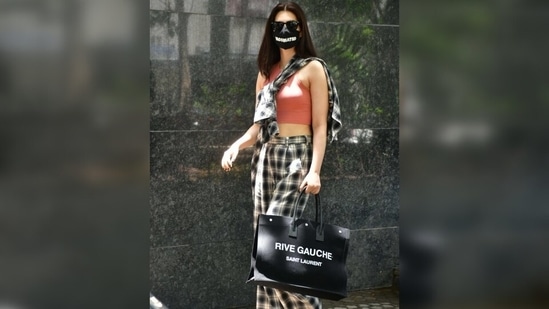 She tied the sleeves of her shirt over her torso and turned the street-style look ultra-glam. She matched the shirt with her pants. (Varinder Chawla) She tied the sleeves of her shirt over her torso and turned the street-style look ultra-glam. She matched the shirt with her pants. (Varinder Chawla)