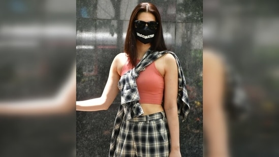 Though Kriti's day-out ensemble is a standout look, it was her face mask that made heads turn. She wore a black face mask with the words 'Vaccinated' written on them in capital letters. (Varinder Chawla) Though Kriti's day-out ensemble is a standout look, it was her face mask that made heads turn. She wore a black face mask with the words 'Vaccinated' written on them in capital letters. (Varinder Chawla)