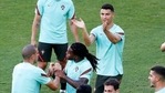 Portugal's Cristiano Ronaldo, right, applauds as Renato Sanches, center, holds the hands of Pepe during a training session at the La Cartuja stadium in Seville.(AP)