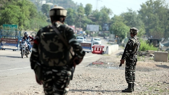 CRPF personnel stand guard at Jammu and Kashmir National Highway at Nagrota, in Jammu on Sunday. (ANI Photo) CRPF personnel stand guard at Jammu and Kashmir National Highway at Nagrota, in Jammu on Sunday. (ANI Photo)