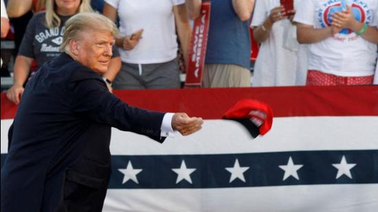 Former US president Donald Trump throws a hat towards the crowd as he arrives for a rally in Wellington, Ohio, US. (AFP) Former US president Donald Trump throws a hat towards the crowd as he arrives for a rally in Wellington, Ohio, US. (AFP)