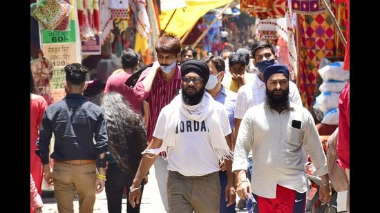 Despite the administration cautioning residents against flouting Covid protocols to prevent a resurgence in cases, many people could be seen huddling together with face masks. (Harsimar Pal Singh/HT)