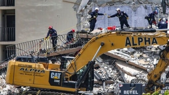 A South Florida Urban Search and Rescue team looks for survivors at the 12-story oceanfront condo that partially collapsed early Thursday. (AP) A South Florida Urban Search and Rescue team looks for survivors at the 12-story oceanfront condo that partially collapsed early Thursday. (AP)