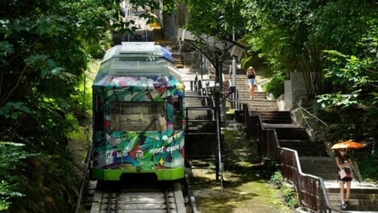 A Peak Tram passes uphill of the Victoria Peak in Hong Kong on June 16, 2021. (AP)